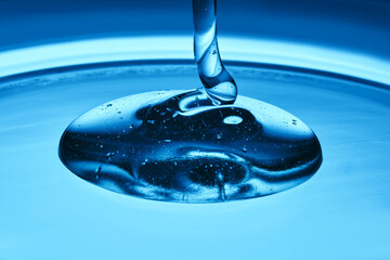 The texture of a cosmetic product in the form of jelly or gel on a blue background.