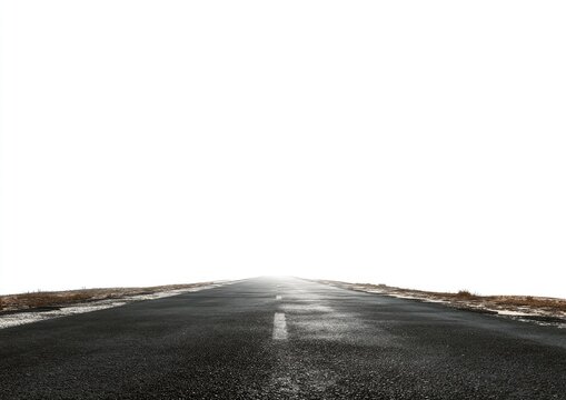 Empty asphalt road stretching into a bright white sky