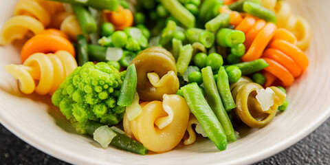 Trottole pasta vegetables green peas, green beans, kohlrabi cabbage, broccoli second course tasty snack fresh delicious gourmet food background on the table rustic food top view copy space