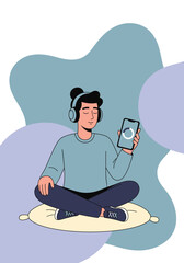 Young man meditating with headphones and smartphone.