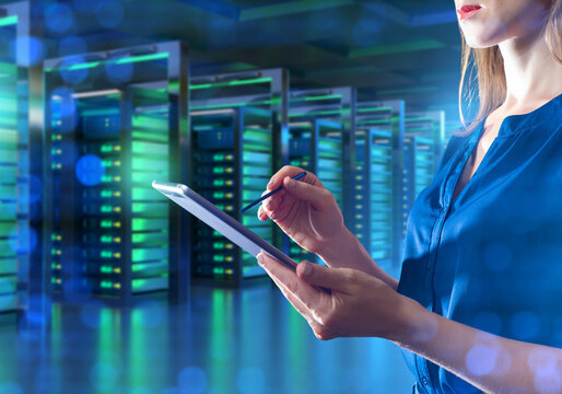 Woman data center manager. Servers for hosting VPS and VDS. System administrator with electronic tablet in hands. Cropped lady in data center. Hosting company manager. Monitoring server equipment