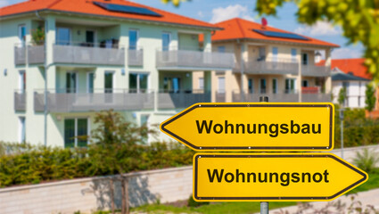  wei Wegweiser zeigen in unterschiedliche Richtungen und sind beschriftet mit Wohnungsbau und...