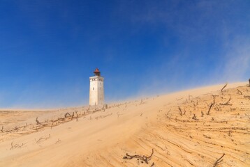 view of the sand dune and Rubjerg Knude lighthouse in Jutland in northern Denmark