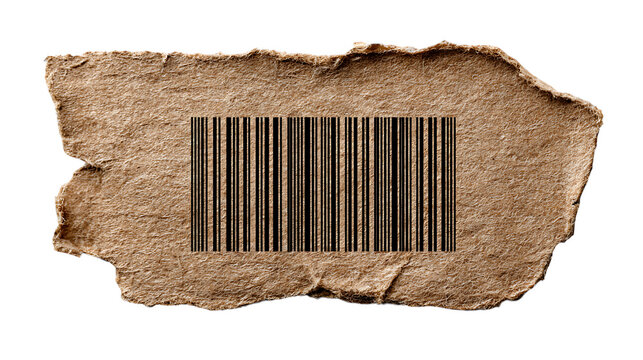 Torn piece of cardboard with a barcode printed on it against white background