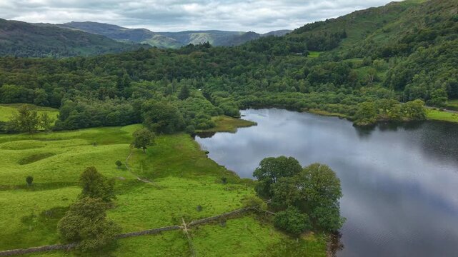 Aerial drone footage flying over tranquil Rydal Water in the Lake District, England