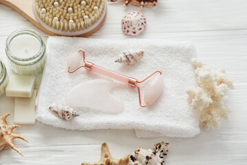 Spa beauty products for body and face home skin care on white wooden background. white towel, bar...