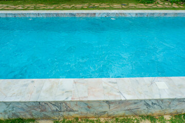 Empty swimming pool with sunbed and white umbrella in resort hotel for vacation leisure and white sand,resort neary sea and beach in summer.