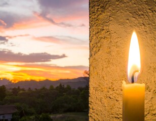 A candle flame against a sunset over hills