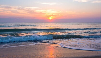 Breathtaking sunrise illuminating the calm ocean waters and a soft sandy shore, with tranquil waves reflecting the warm hues of dawn