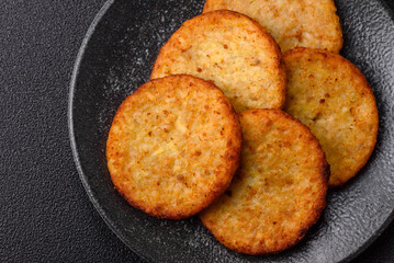 Hash browns, fried potato and onion pancakes with spices for breakfast. Fried hash browns