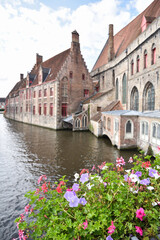 Cityscape in the Old Town of Bruges with Historic Buildings, Canal, and Flowers