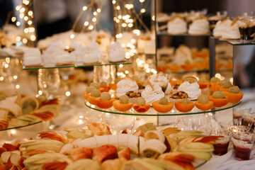 Elegant Dessert Table with Fruit Tartlets and Pastries Under Warm Lighting at a Luxurious...