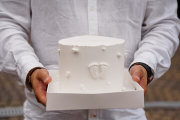 Loving Father Holding Baby Footprint Cake: Celebration of New Birth, White Frosting, Textured Linen...