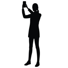 Woman holding smartphone for selfie silhouette