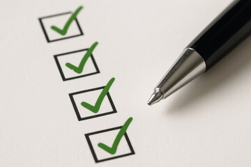 Checklist: Close-up of a checklist with a pen, each box marked with a green check mark, indicating a sense of completion. The image is a symbol of tasks being managed, organized, and accomplished.
