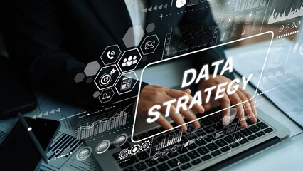 Business Professional Working on Data Strategy with Digital Overlay of Graphs and Icons in Modern Office Environment. Asymptotic smart data analytic.
