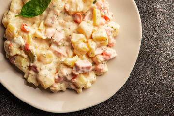 Potato salad ham, potato, tomato, carrot, mayonnaise tasty snack fresh delicious gourmet food background on the table rustic top view copy space