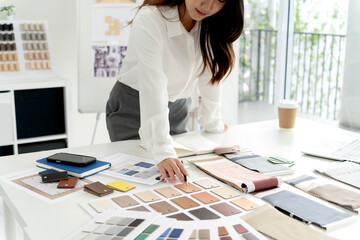 Dedicated professional meticulously curates materials for environmentally conscious architectural design. Innovation meets sustainability in bright creative studio environment