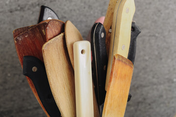 Collection of old knives with wooden and plastic handles. Rustic vintage kitchen tools in closeup...