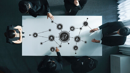 A dynamic business team collaborates around a modern conference table, surrounded by technology...