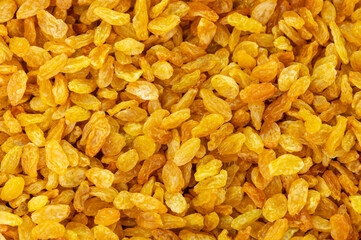 Background with golden raisins. Food texture. Top view of dried grapes