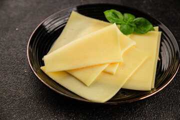 Gouda cheese slices hard cheese variety natural product tasty snack fresh delicious gourmet food background on the table rustic top view copy space