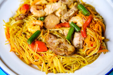 Plate of Tasty Spicy Singapore Noodles With Meat and Vegetables