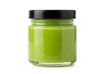 Fresh vibrant green pesto in a jar ready to use for gourmet meals and culinary creations now