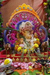 Ganapati festival celebration at home with a beautifully decorated Ganesh idol, flowers, lights, and traditional offerings, symbolizing devotion, prosperity, and cultural heritage in a festive atmosph