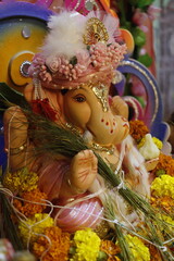 Ganapati festival celebration at home with a beautifully decorated Ganesh idol, flowers, lights, and traditional offerings, symbolizing devotion, prosperity, and cultural heritage in a festive atmosph