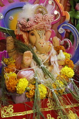 Ganapati festival celebration at home with a beautifully decorated Ganesh idol, flowers, lights, and traditional offerings, symbolizing devotion, prosperity, and cultural heritage in a festive atmosph