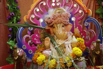 Ganapati festival celebration at home with a beautifully decorated Ganesh idol, flowers, lights, and traditional offerings, symbolizing devotion, prosperity, and cultural heritage in a festive atmosph