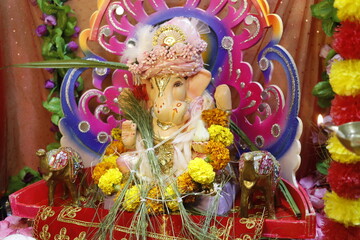 Ganapati festival celebration at home with a beautifully decorated Ganesh idol, flowers, lights, and traditional offerings, symbolizing devotion, prosperity, and cultural heritage in a festive atmosph