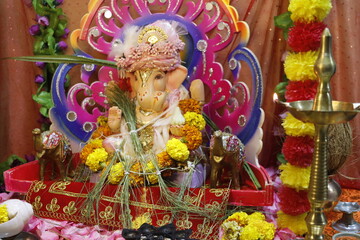 Ganapati festival celebration at home with a beautifully decorated Ganesh idol, flowers, lights, and traditional offerings, symbolizing devotion, prosperity, and cultural heritage in a festive atmosph