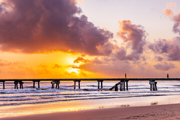 Fototapeta premium Butwani bridge and Malindi Pier area is a popular waterfront location known for stunning sunrises over the Indian Ocean. The pier is a concrete jetty that stretches about 400 meters into the ocean and