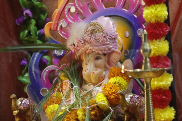 Ganapati festival celebration at home with a beautifully decorated Ganesh idol, flowers, lights, and traditional offerings, symbolizing devotion, prosperity, and cultural heritage in a festive atmosph