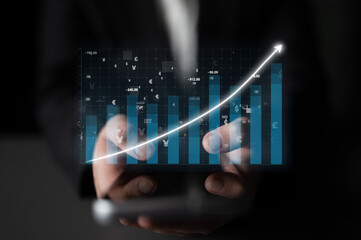 A businessman presents a smartphone showing an upward trending graph, symbolizing financial growth and market analysis in a corporate setting. Impute