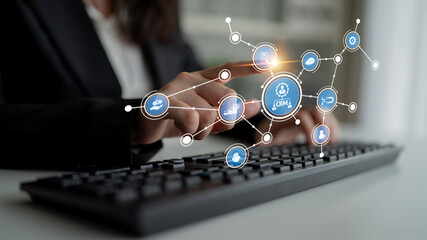 Business professional engages with an innovative CRM interface on a computer keyboard, showcasing the integration of technology in modern customer relationship management. Tessel