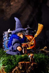image of cheerful witch sitting on tree stump covered with moss and jack o lanterns on All Saints...