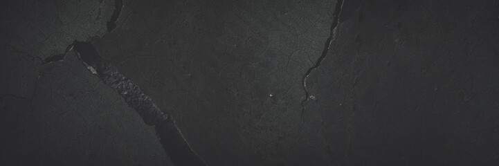 Dark wide panoramic background. Peeling paint on a concrete wall. Faded dark texture of old cracked...