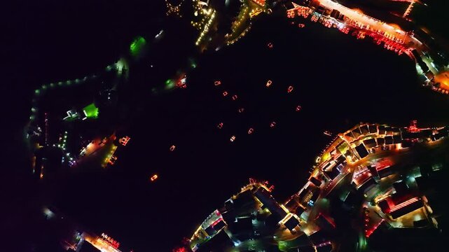 At dusk the reflections of the lights from the village the lake in Chinese-style structures with colorful lights lined the waterfront. Ban Rak Thai is a popular tourist attraction in Mae Hong Son