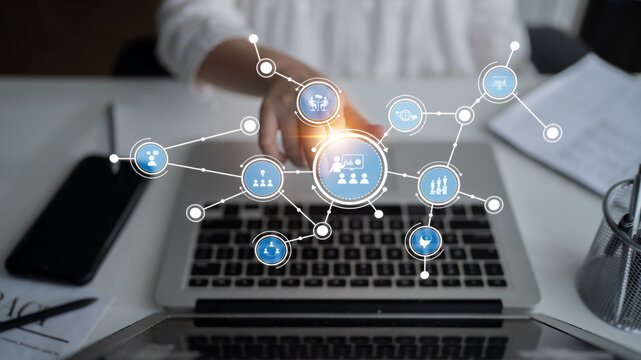 Visual representation of digital connection with icons over a laptop screen, symbolizing modern communication and collaboration in a professional workspace setting. Tessel - Powered by Adobe