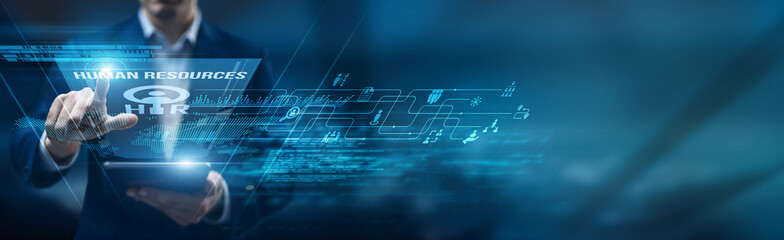 The HR manager is using a smart tablet for performance monitoring of human resources systems,...