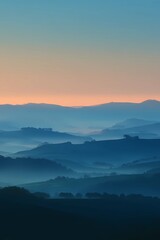 Obraz premium Serene landscape of fog-covered hills under soft dawn light, evoking stillness and natural beauty.