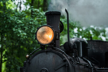 Detailed headlight and chimney of old steam engine.