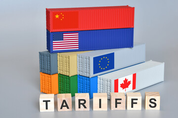 Wooden cubes with the word "Tariffs" and shipping containers with US, China, Canada and EU flags. An idea for a new tariff war.
