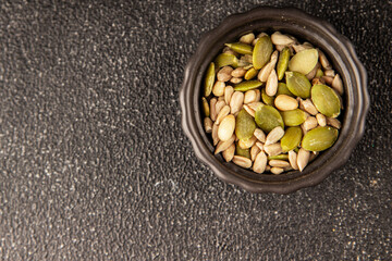 Seed mix sunflower seeds and pumpkin seeds natural product tasty snack fresh delicious gourmet food background on the table rustic top view copy space keto and paleo diet vegan and vegan food