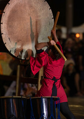 musician playing traditional Japanese taiko drum, Kumi-daiko performance