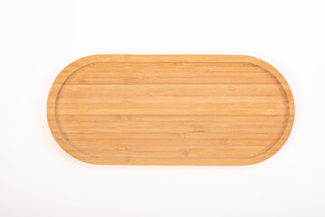 Beautiful wooden kitchen cutting board placed on a white background, selective focus. Top view.
