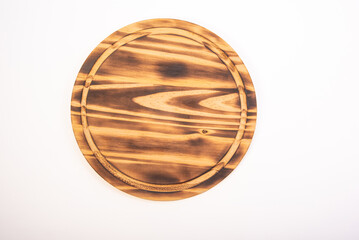 Beautiful wooden kitchen cutting board placed on a white background, selective focus. Top view.
